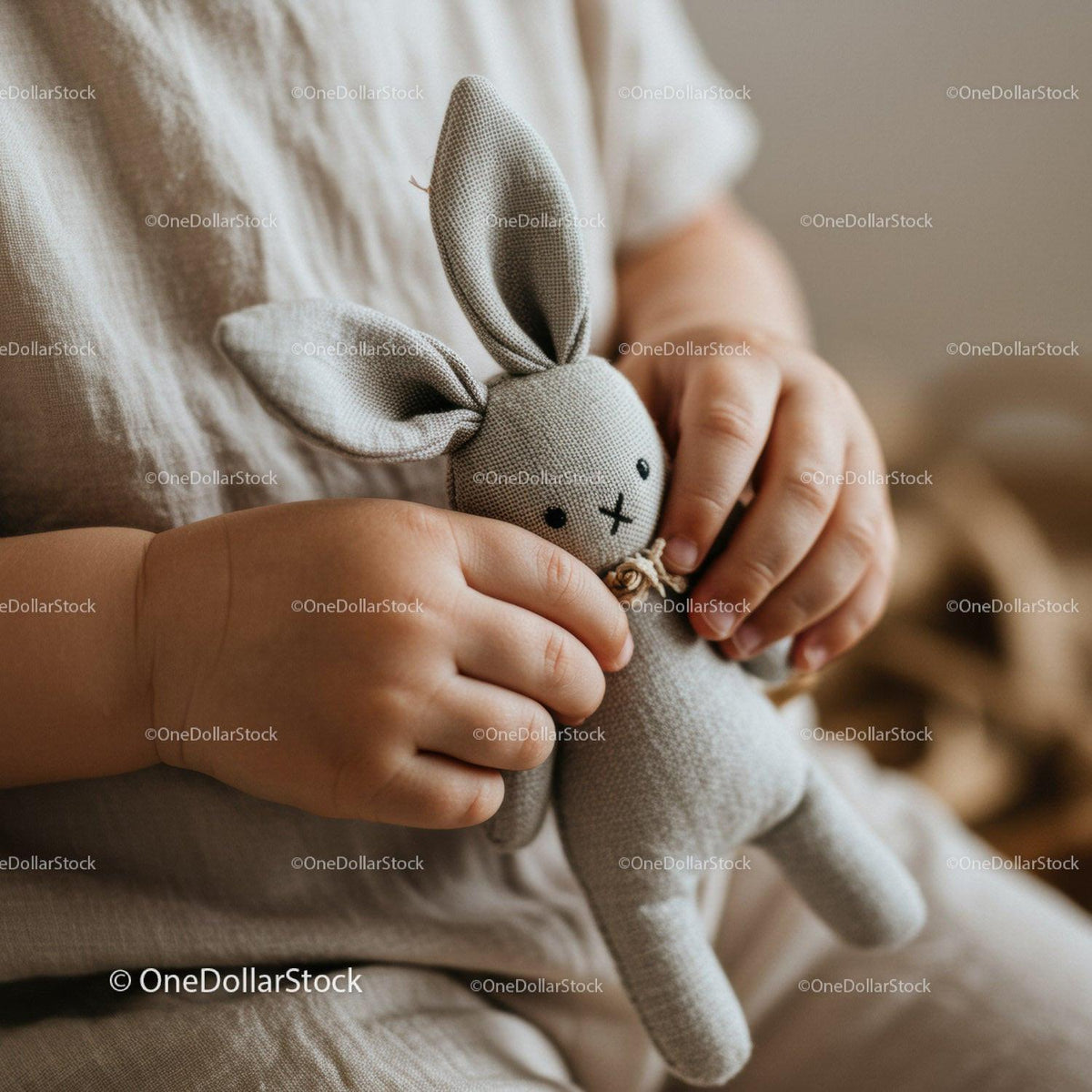 Toddler holding soft fabric bunny toy close up