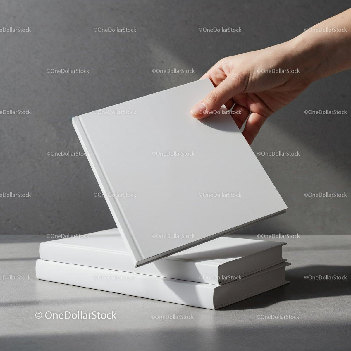 Hand picking a blank white book from stack JPG Mockup Image preview