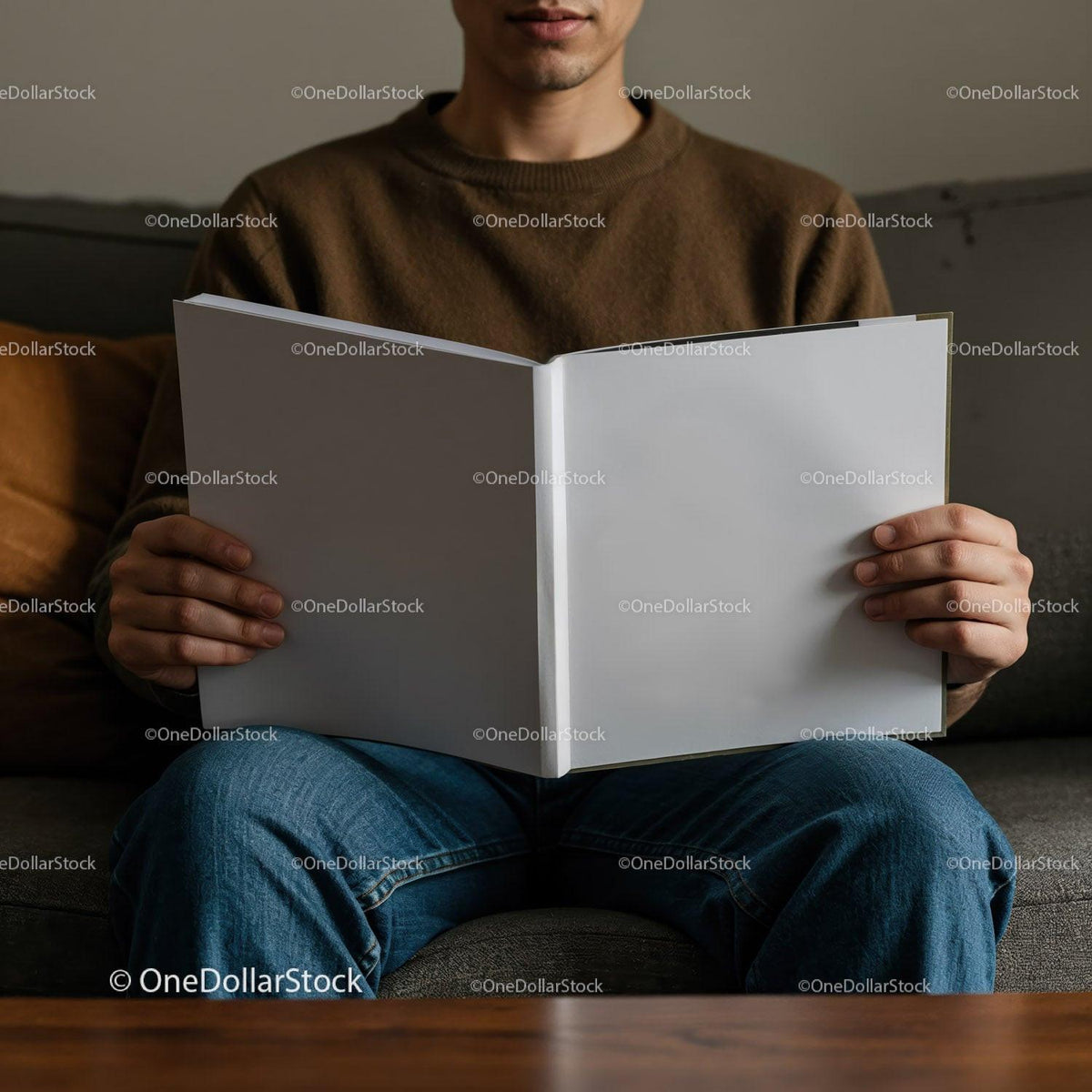 Man Sitting on Couch Holding Blank Open Book JPG Mockup Image preview