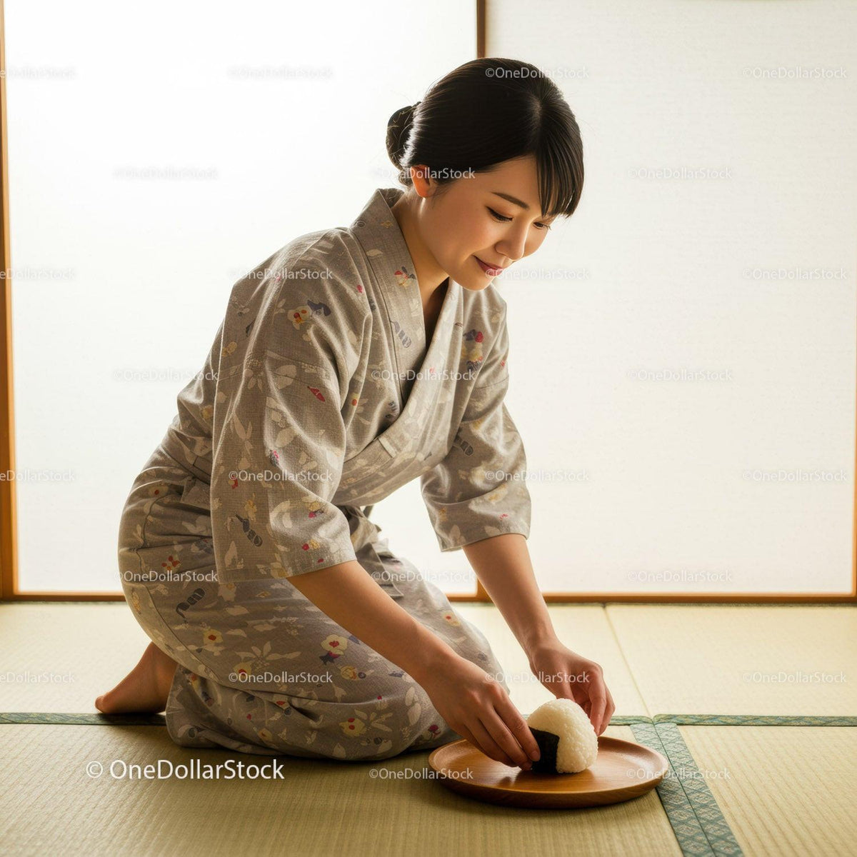 Woman in traditional kimono serving rice ball on tray