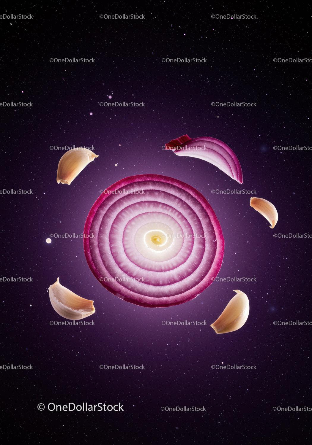 Red onion slice with garlic cloves in cosmic background