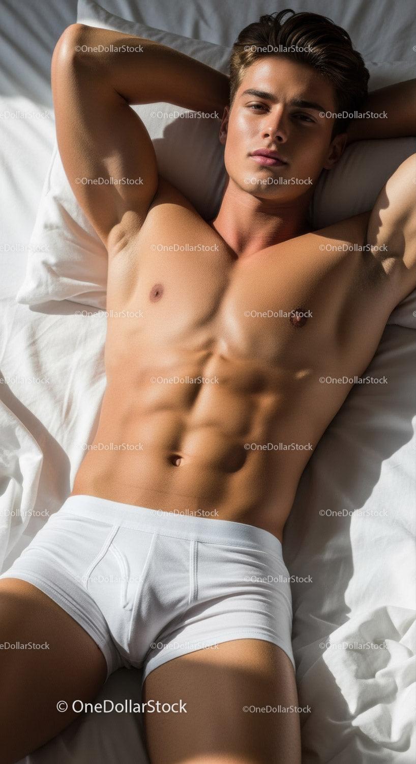 Young muscular man relaxing on bed in white underwear