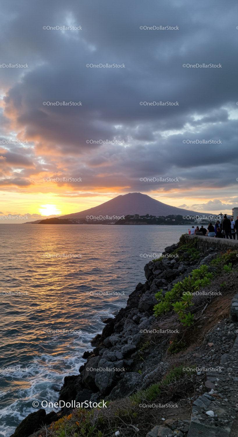 Sunset Over Volcanic Mountain and Rocky Coastline at Dusk