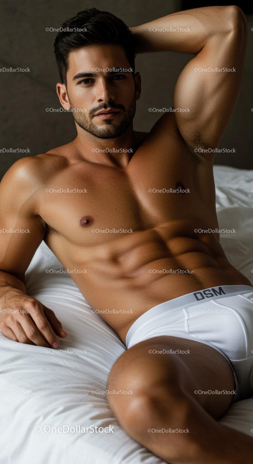 Fit man relaxing on bed in white underwear
