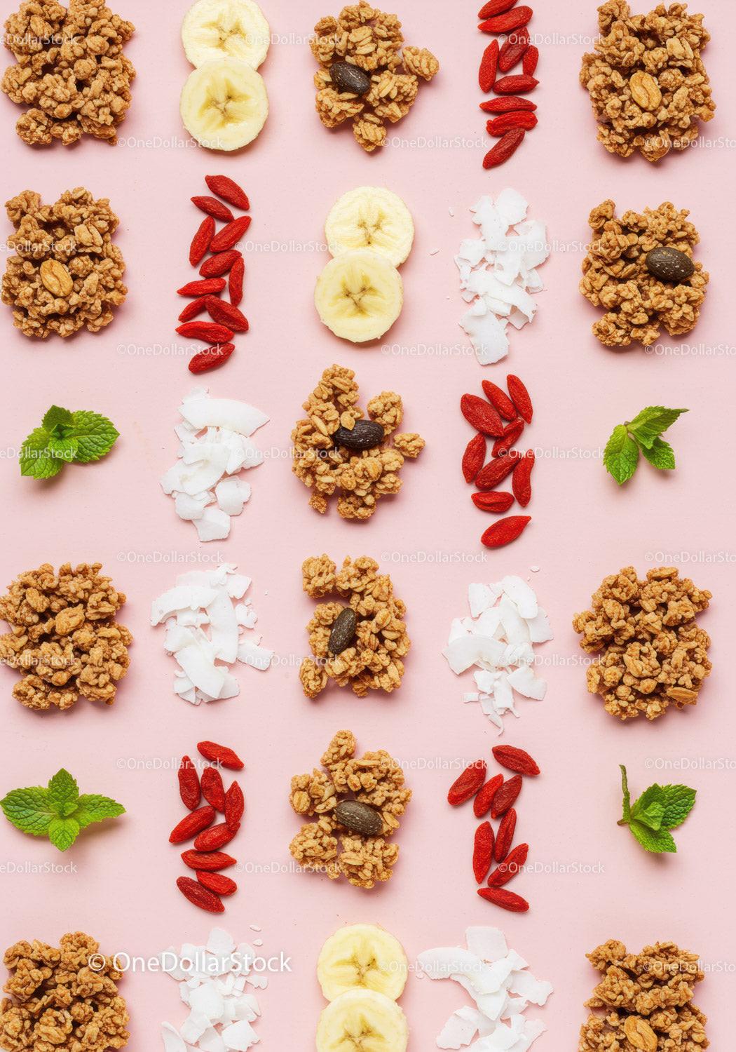 Healthy breakfast ingredients neatly arranged on pink background