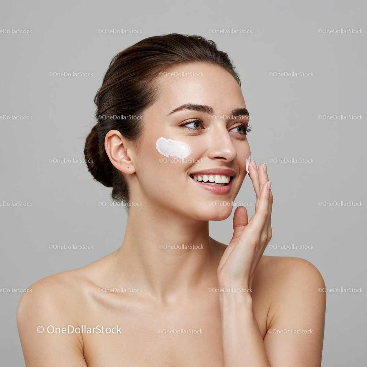 Young Woman Applying Facial Moisturizer With Skincare Products