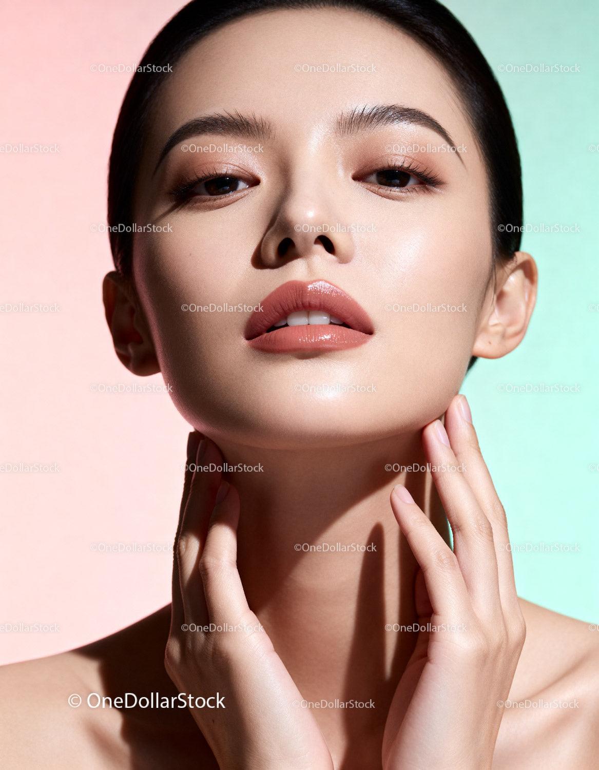 Close-up portrait of young woman with glowing skin