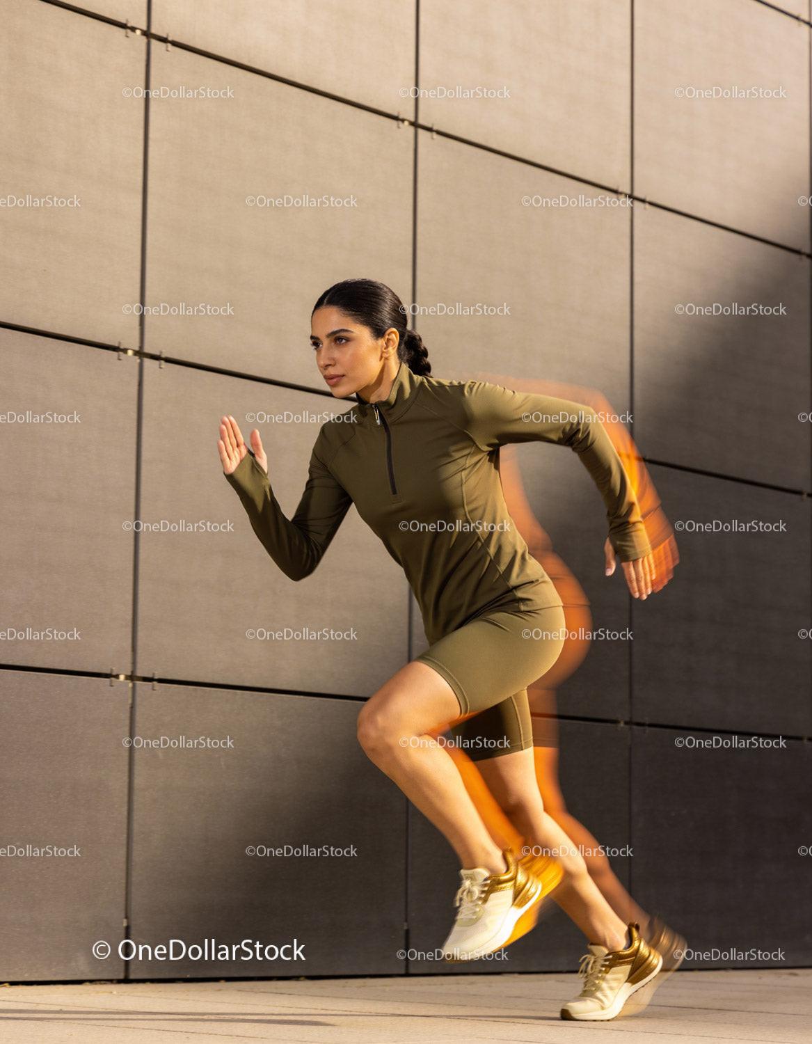 Athletic woman sprinting powerfully outdoors in urban setting