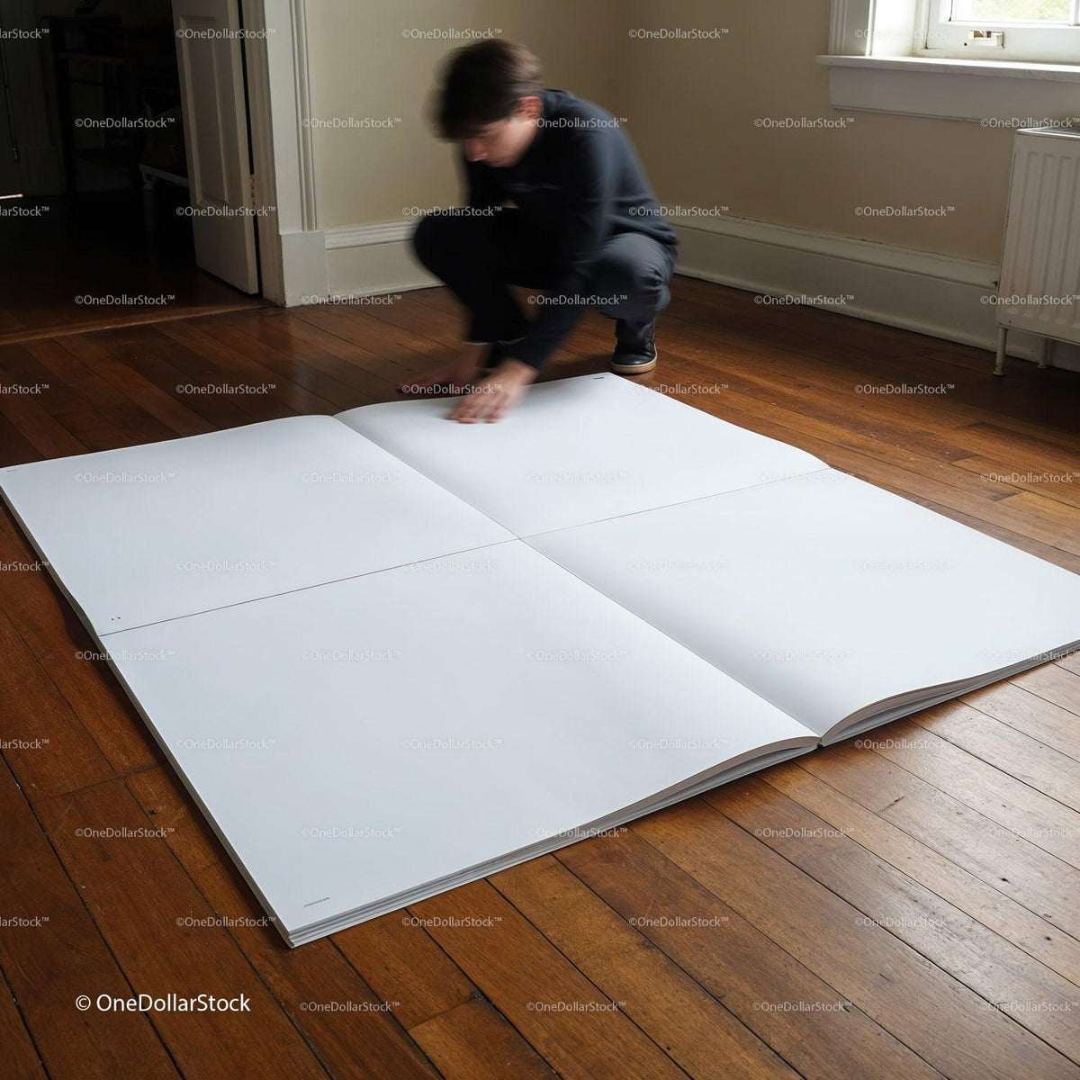 Person examining large blank pages on wooden floor JPG Mockup Image preview