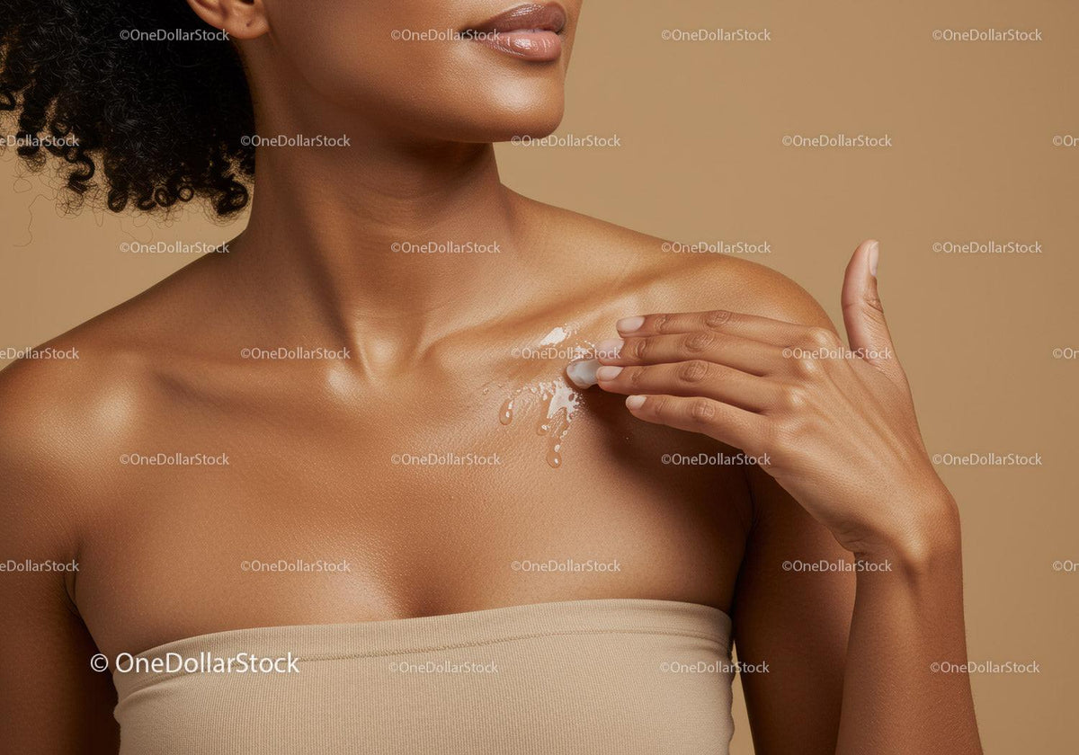Close-up of a woman applying moisturizer with glowing skin and elegant pose