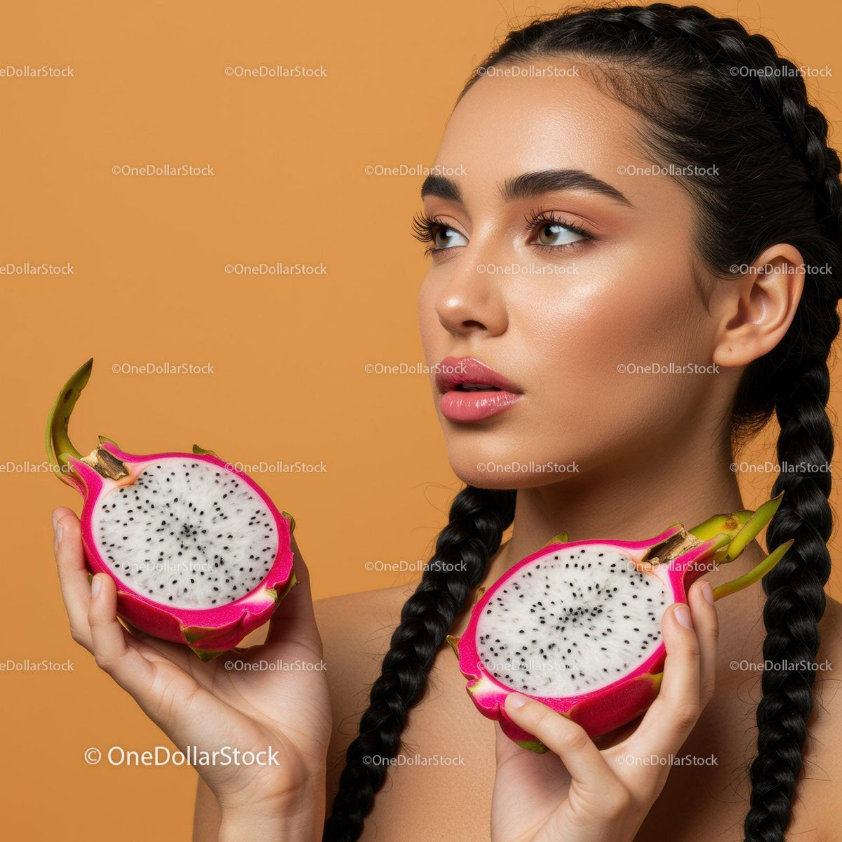 Beautiful woman with long braids holding vibrant dragon fruits