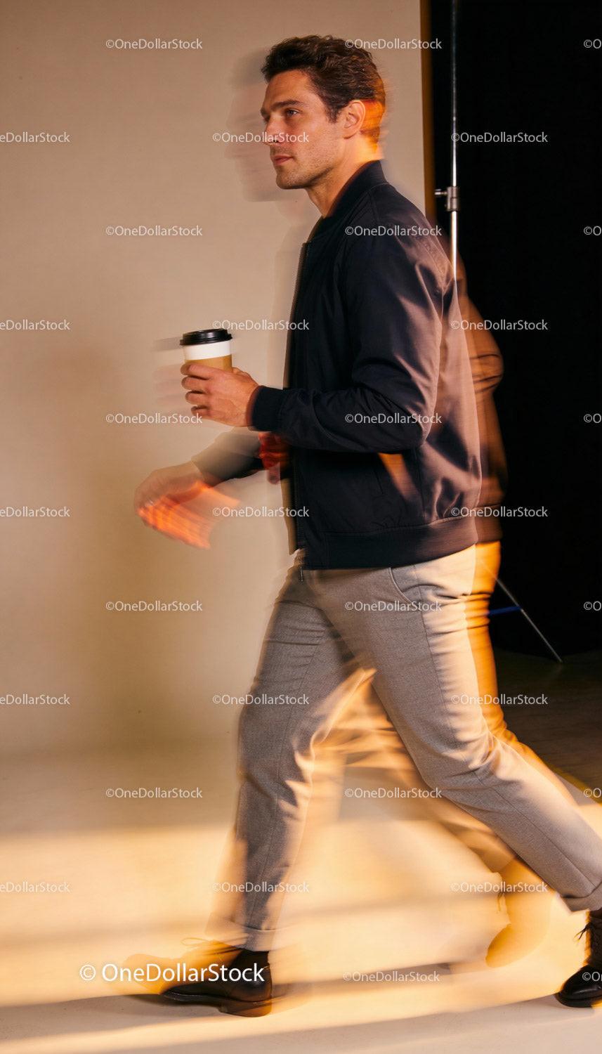 Stylish man walking confidently with coffee cup