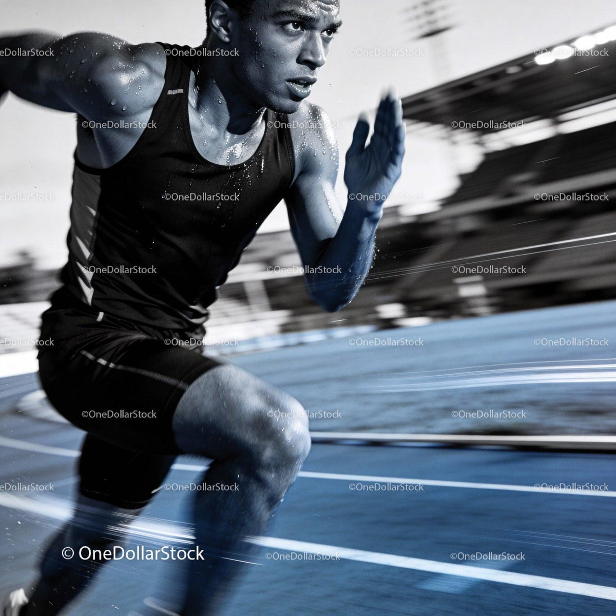 Focused male sprinter pushing limits on outdoor track