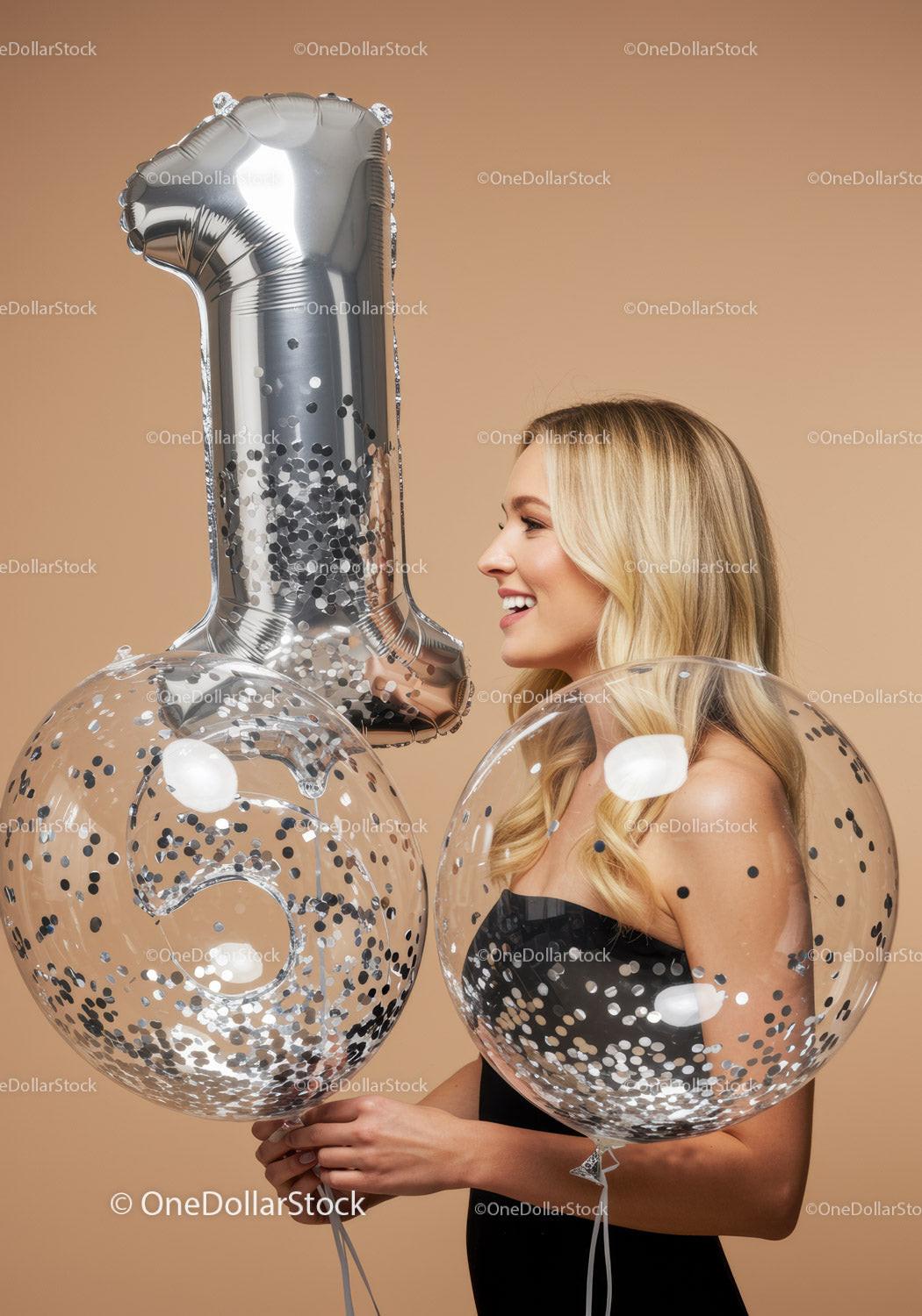 Smiling woman celebrating first birthday with balloons