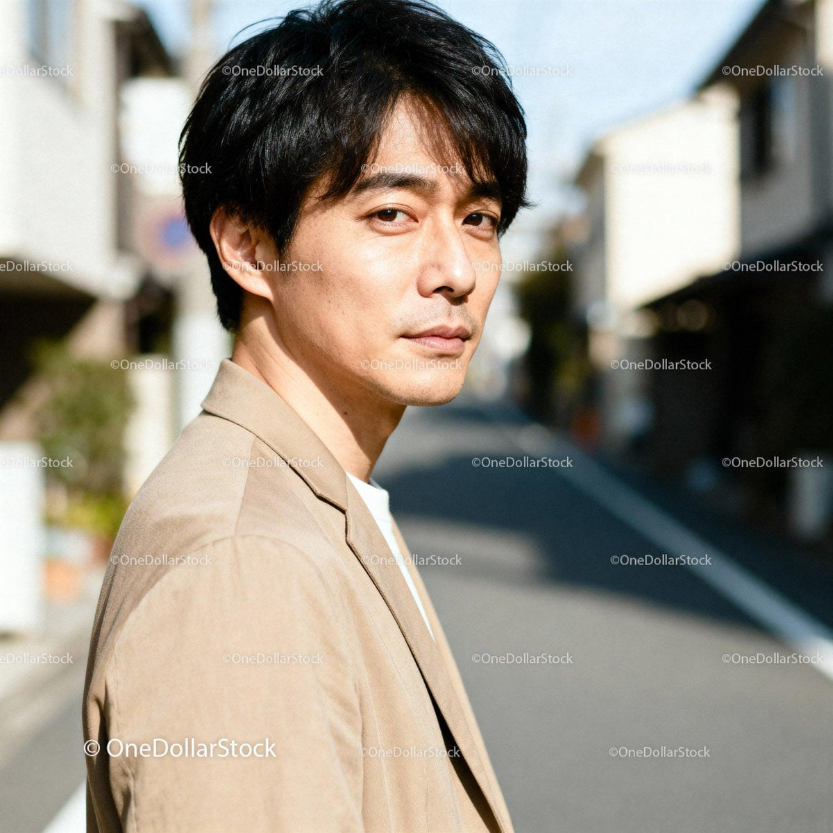 Thoughtful man posing outdoors on a quiet street