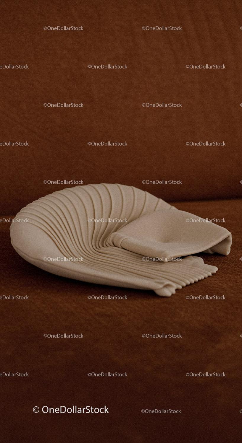 Elegant white ceramic shell sculpture on brown background