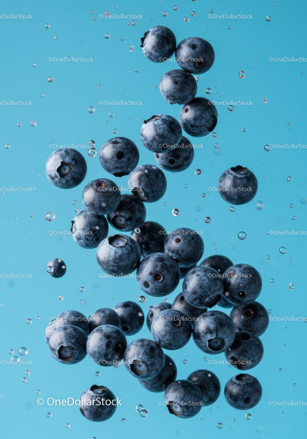 Fresh blueberries suspended in clear water with bubbles