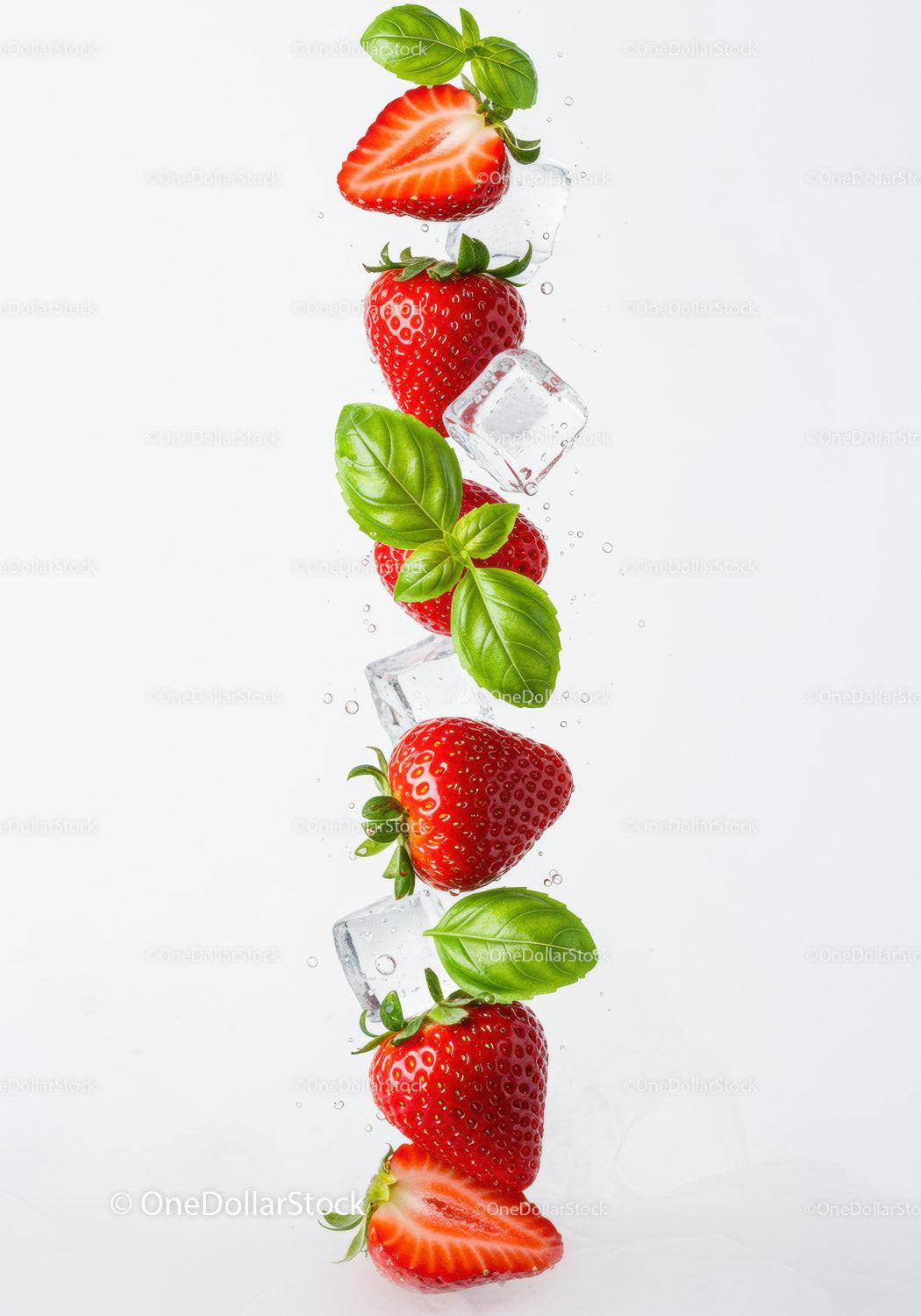 Fresh strawberries with basil and ice cubes in water