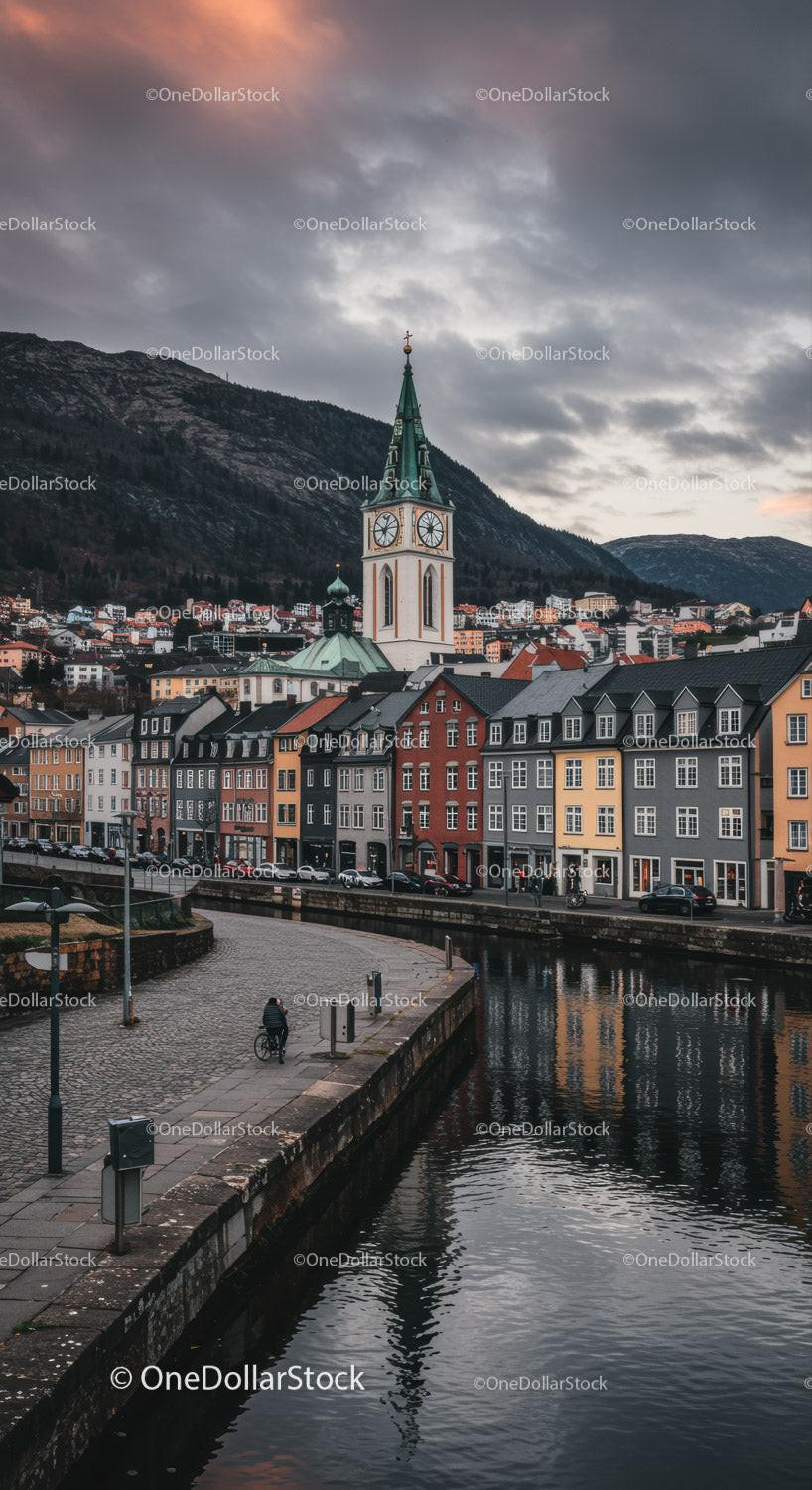 Colorful Cityscape with Historic Church Tower and Mountain Background