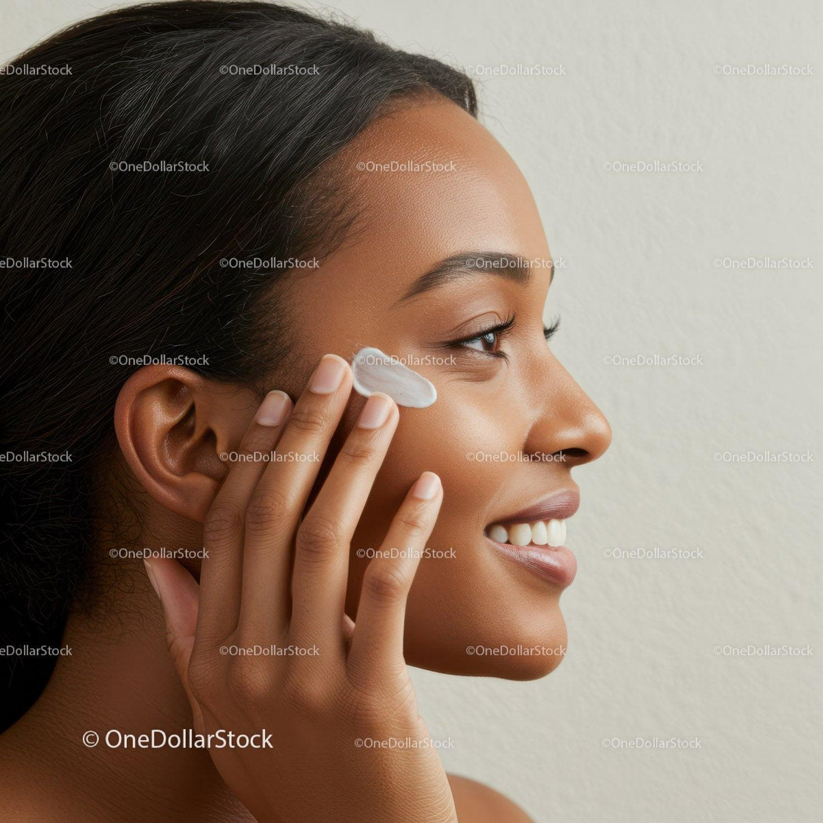 Young Woman Applying Skincare Cream for Radiant Skin