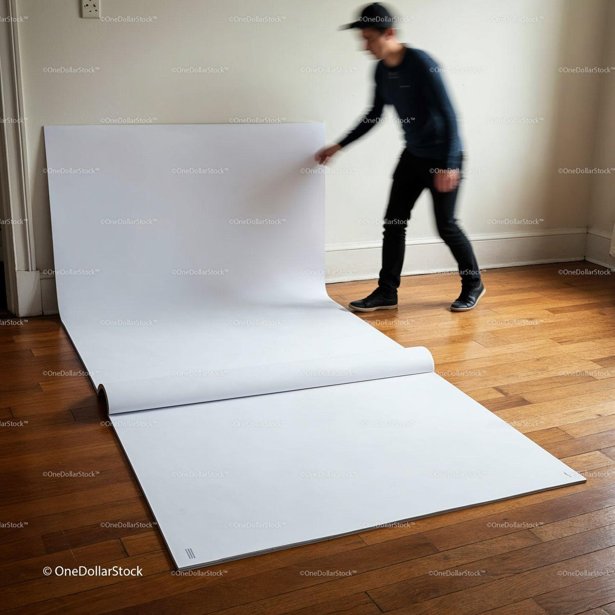 Person Unrolling Large White Sheet on Wooden Floor JPG Mockup Image preview