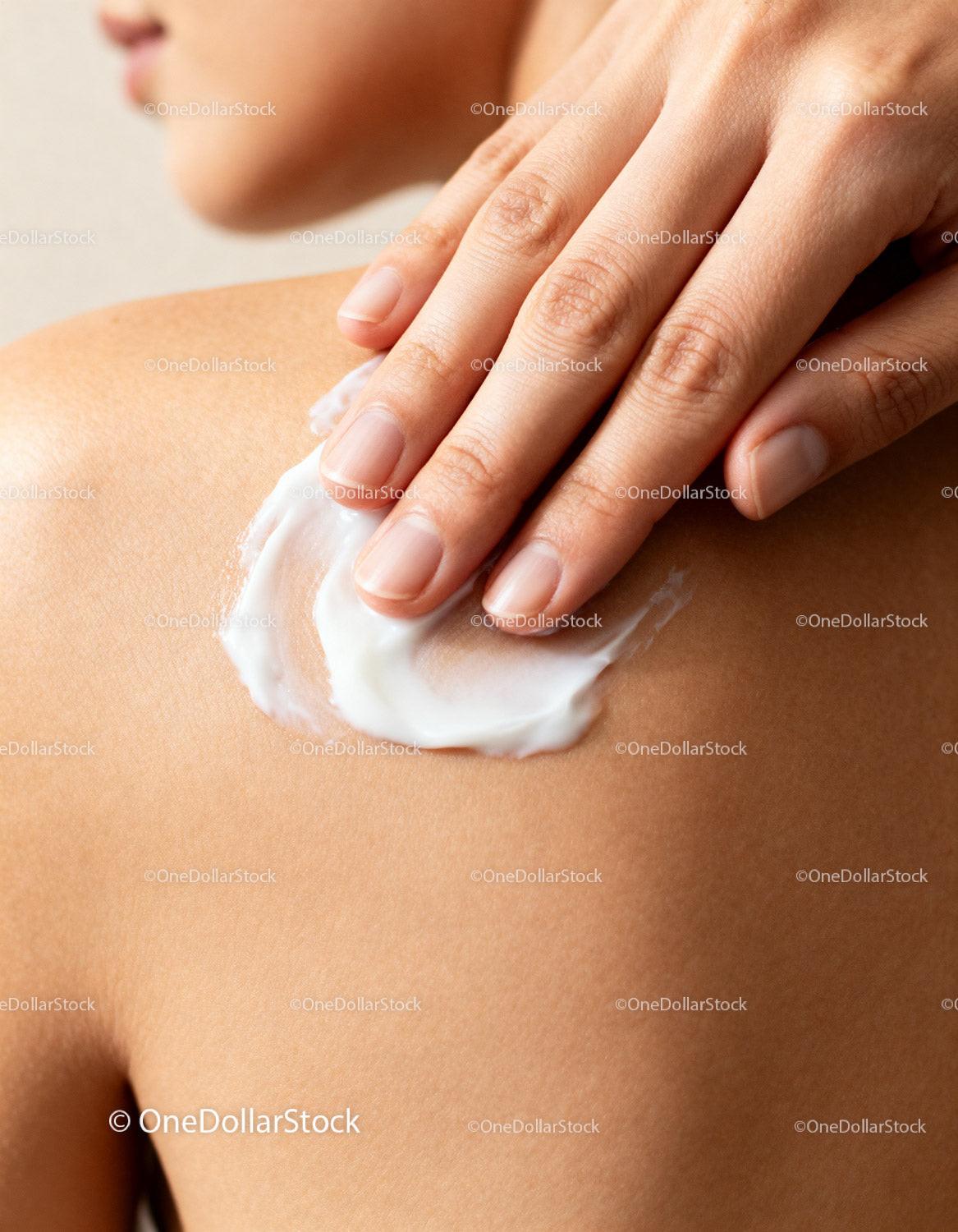 Woman Applying Moisturizer Cream on Shoulder Skin