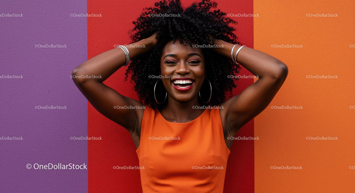 Smiling Woman with Curly Hair in Bright Orange Dress Against Colorful Wall