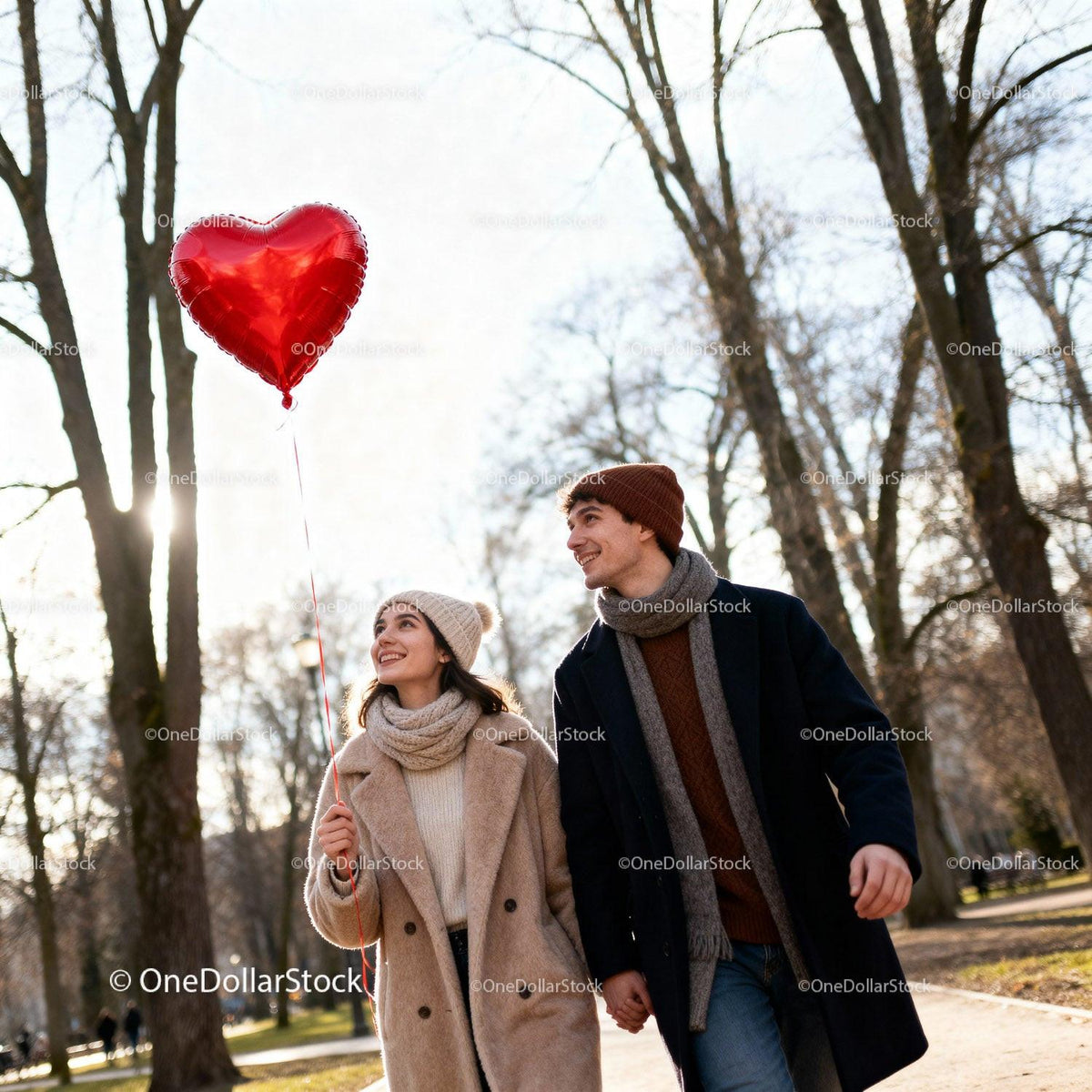 Young couple walking in park with heart balloon