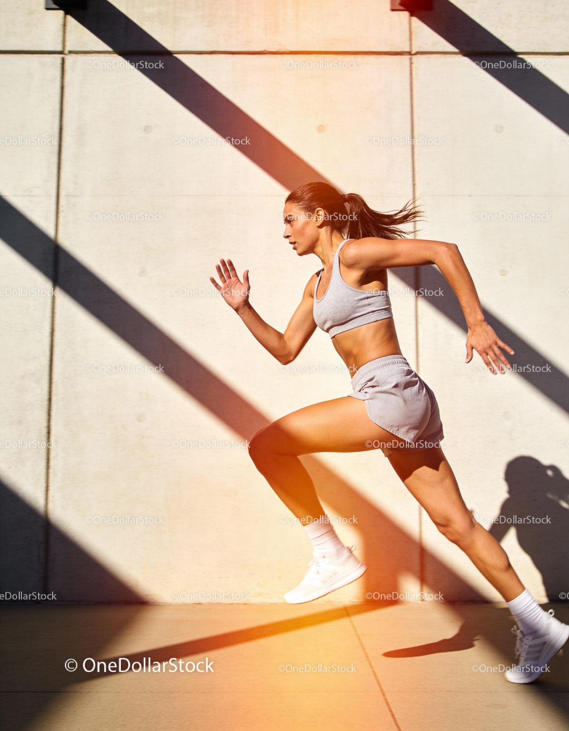 Athletic woman sprinting outdoors with powerful stride