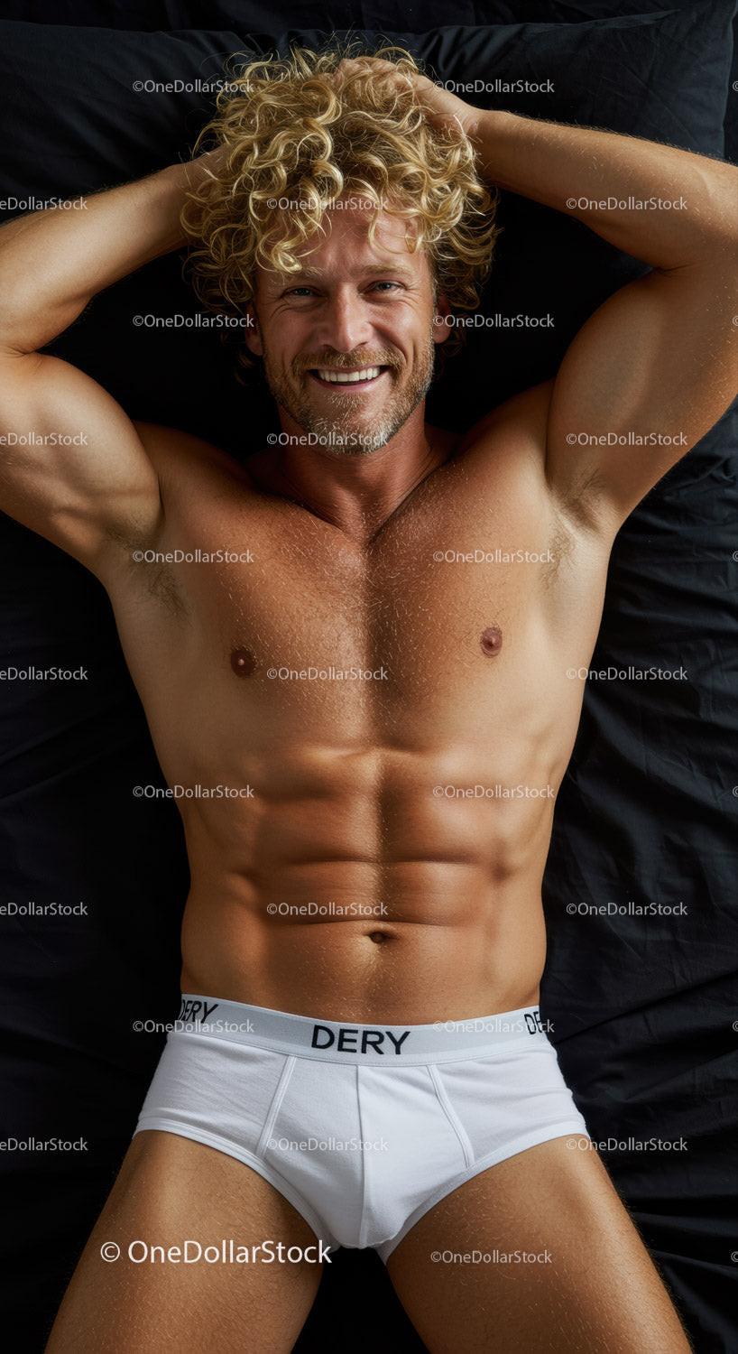 Smiling man with curly hair relaxing in white briefs
