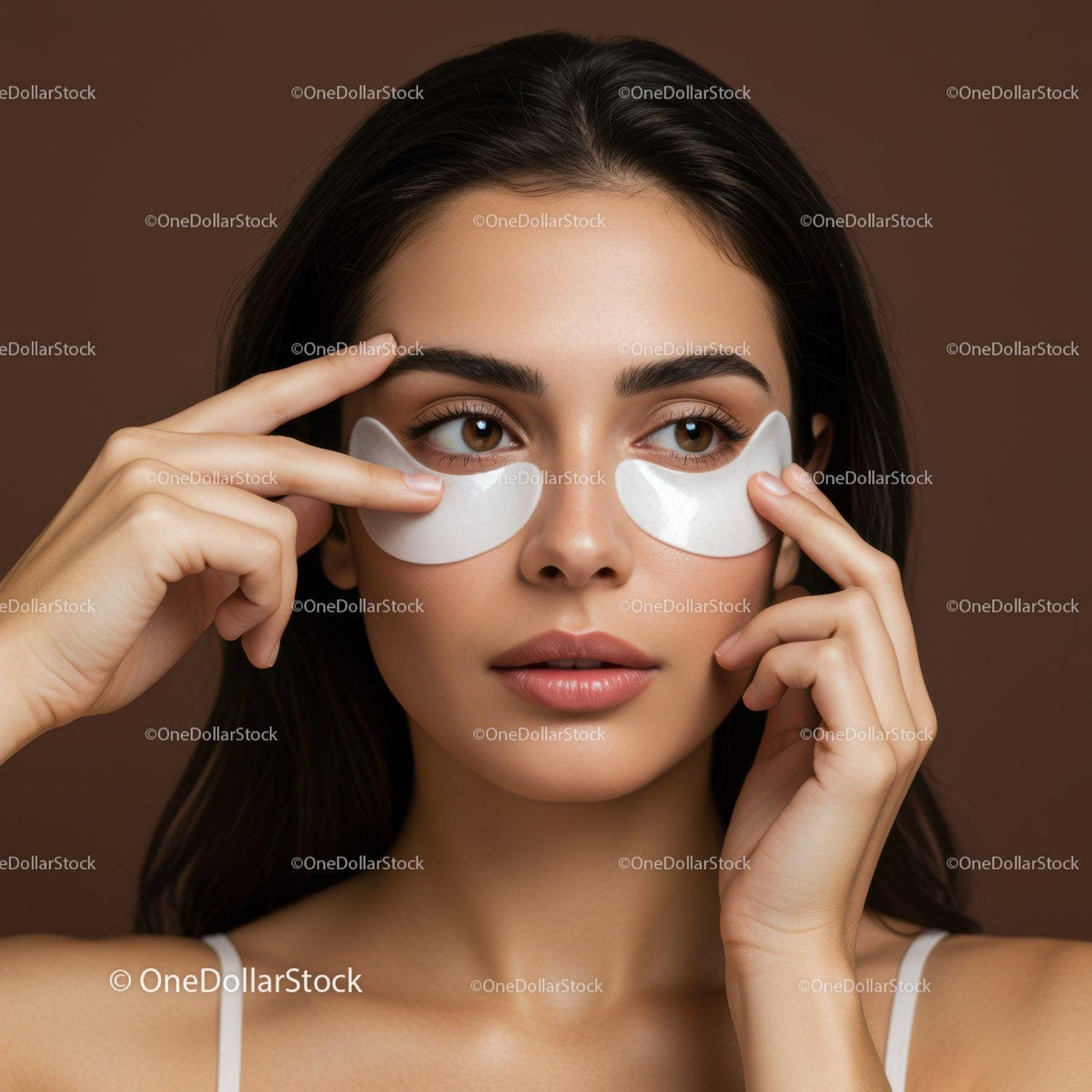 Beautiful Woman with Eye Patches Engaged in Facial Skincare Routine