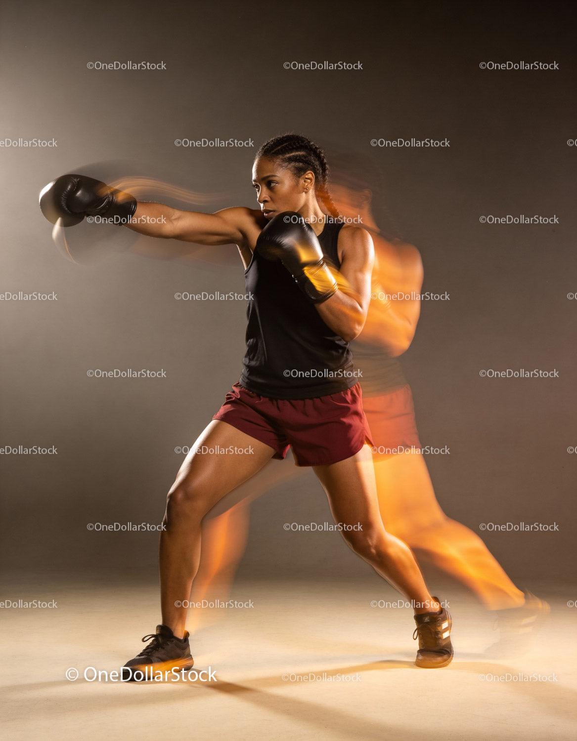 Focused female boxer delivering a powerful punch