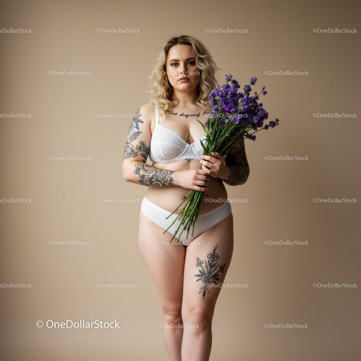 Elegant Tattooed Woman Holding Purple Flowers in White Lingerie