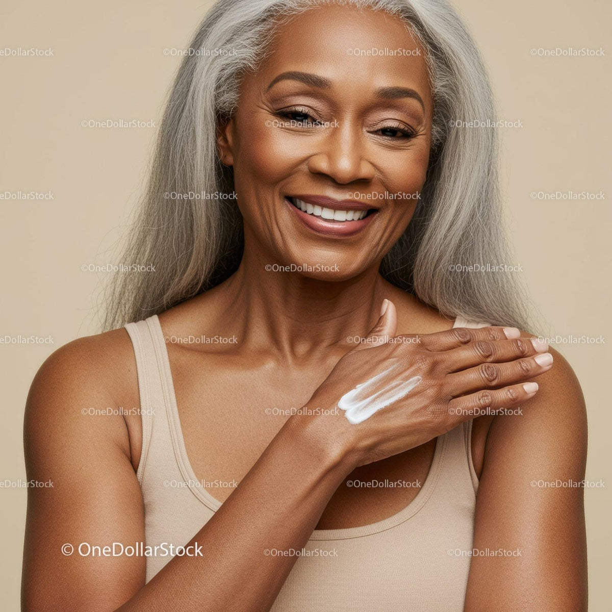 Joyful Senior Woman Applying Skincare Cream with Gray Hair