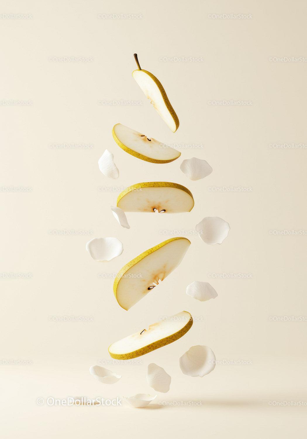 Floating sliced pear with delicate white petals