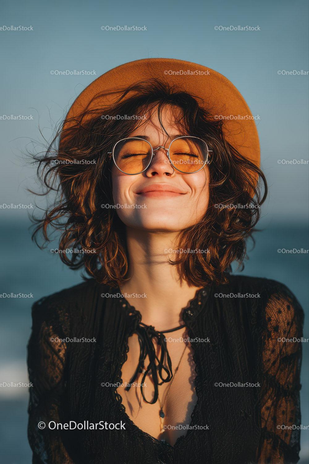 Smiling Woman with Curly Hair Wearing Straw Hat and Sunglasses at Beach