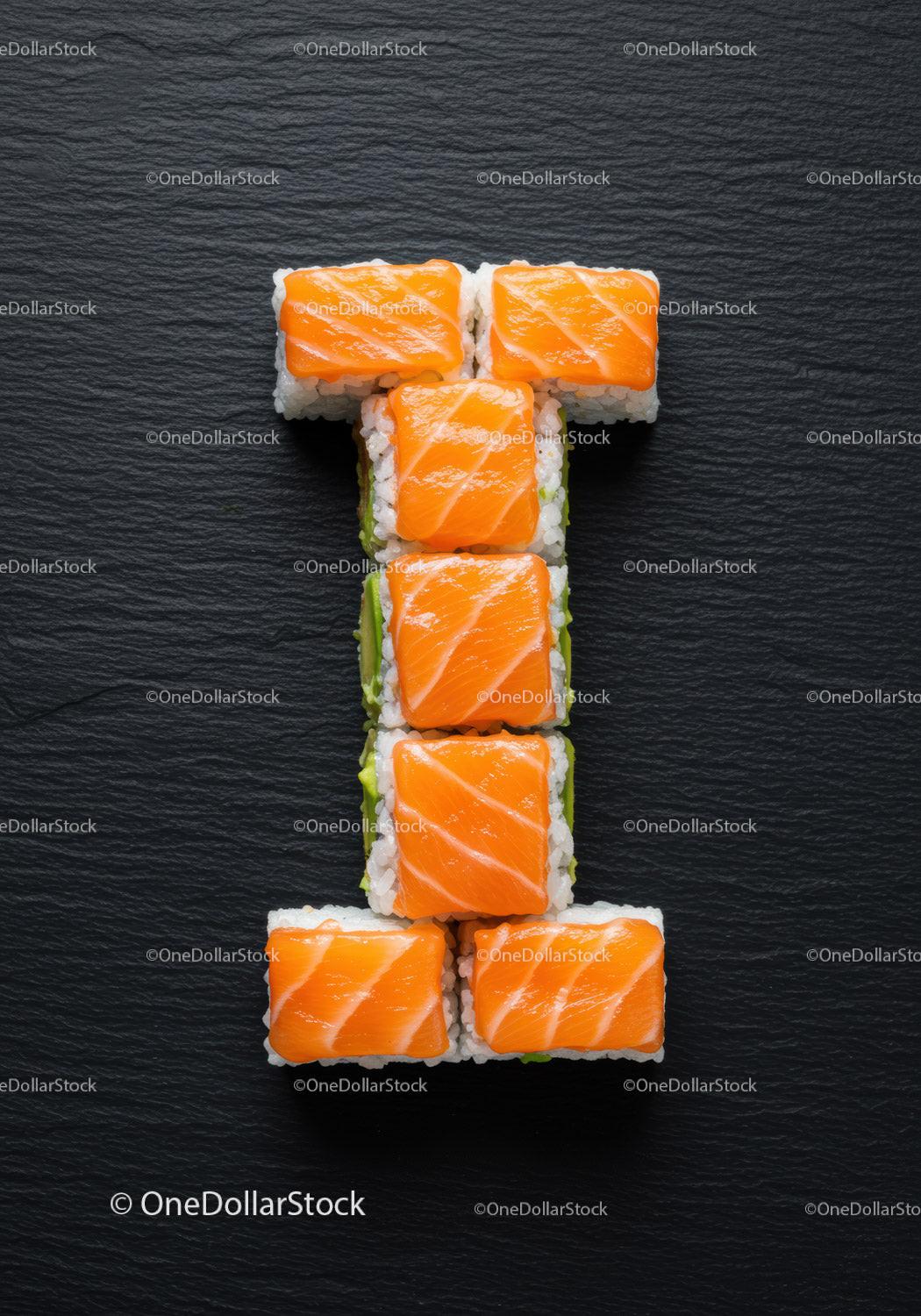 Fresh salmon sushi rolls arranged in a T shape