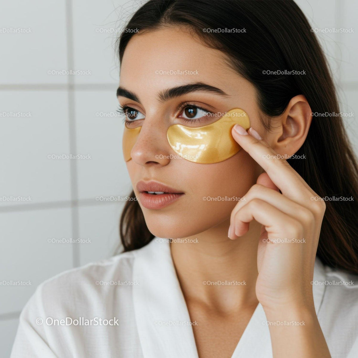 Elegant Woman Applying Gold Under-Eye Patches for Skin Rejuvenation