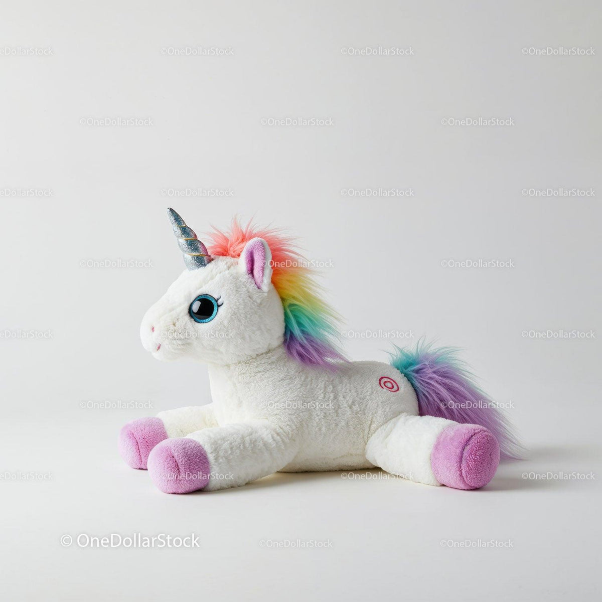 White plush unicorn toy with rainbow mane, tail, and silver horn on white background