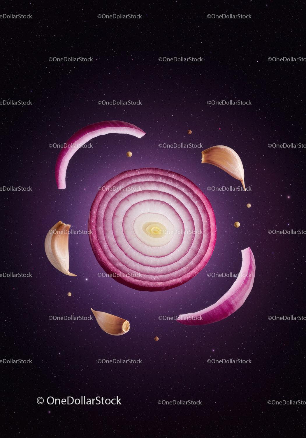 Red onion and garlic cloves floating on dark background