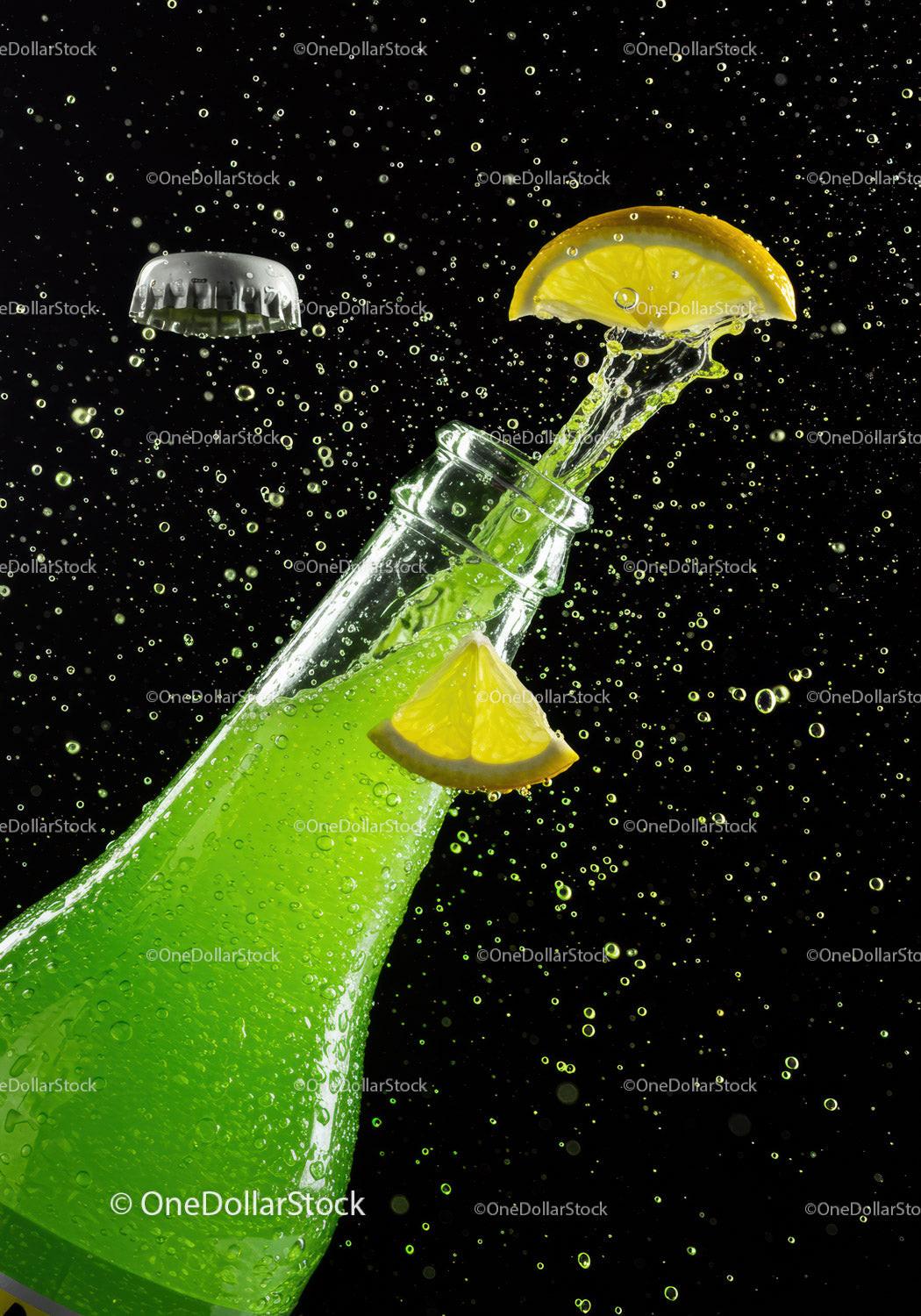 Refreshing green soda bottle with lemon splash