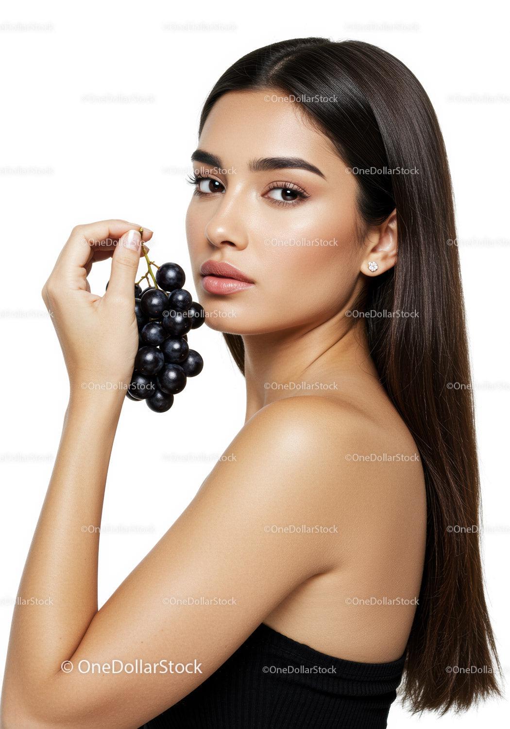 Elegant Woman with Black Grapes for Health and Beauty Concept