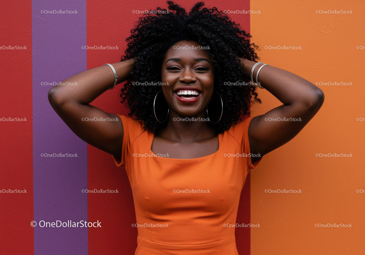 Joyful Black Woman Wearing Orange Dress Against Bright Colorful Wall