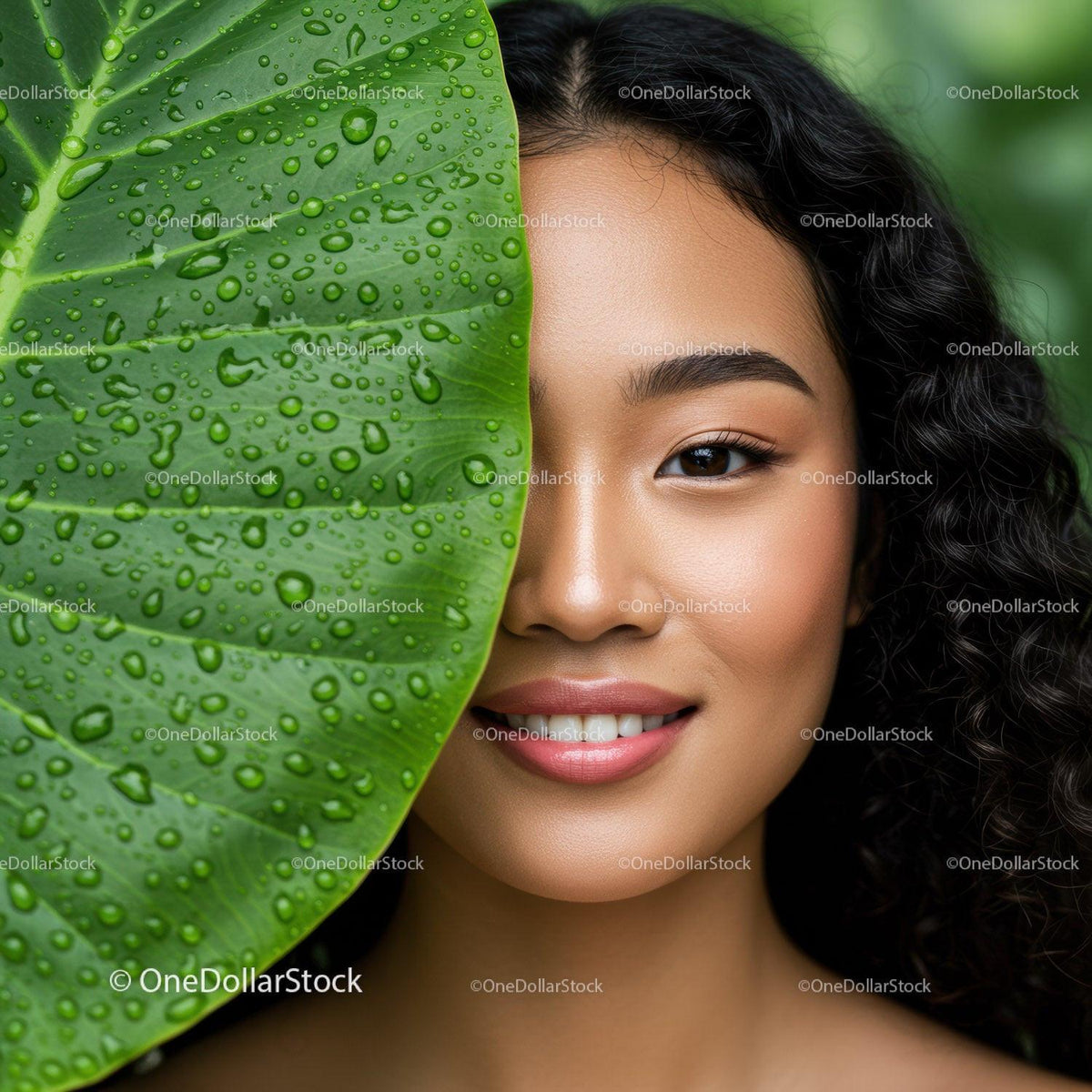 Close-Up of Smiling Woman with Curly Hair Behind Large Green Leaf with Water Drops
