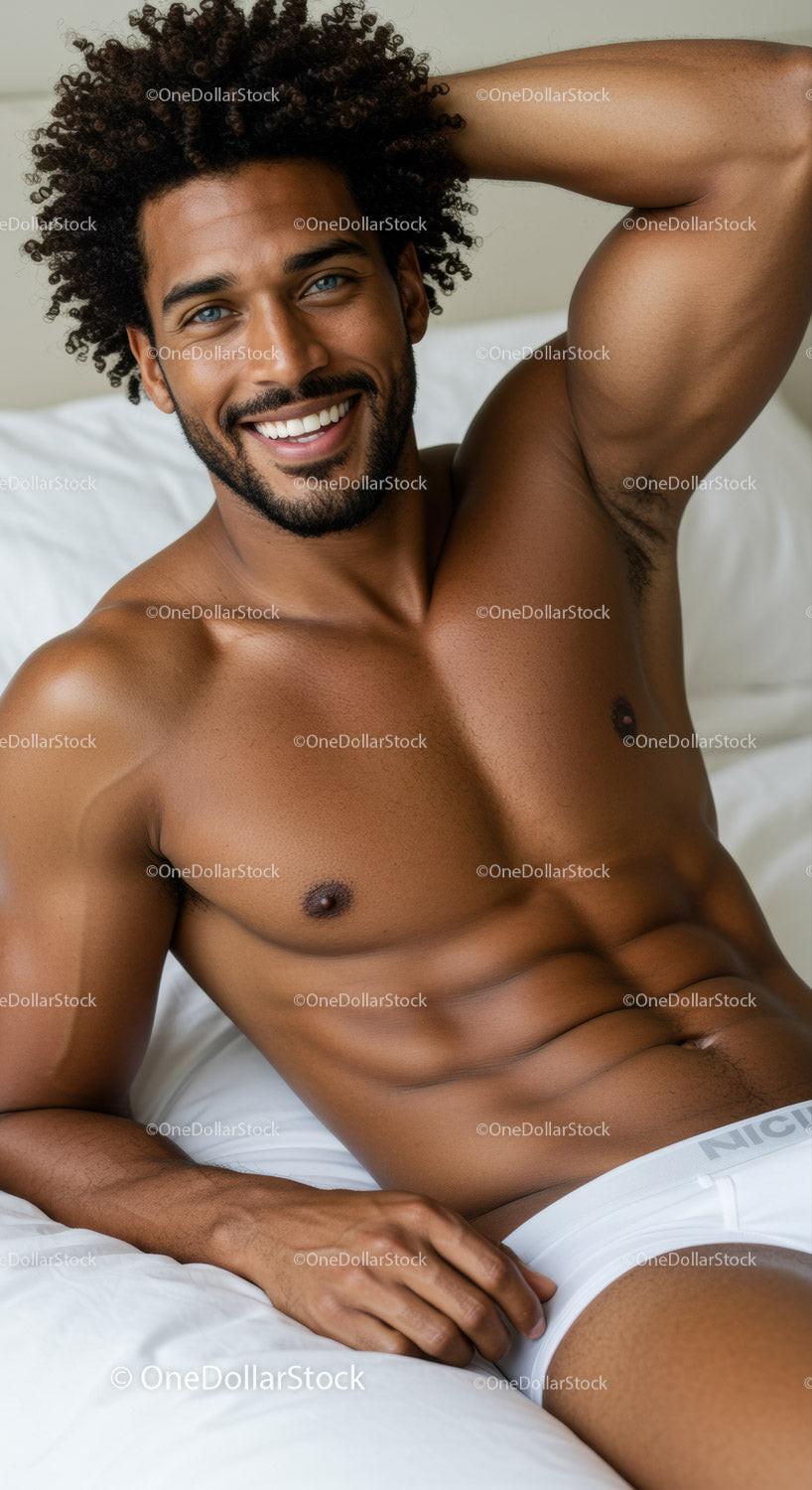 Smiling man relaxing on bed in white underwear