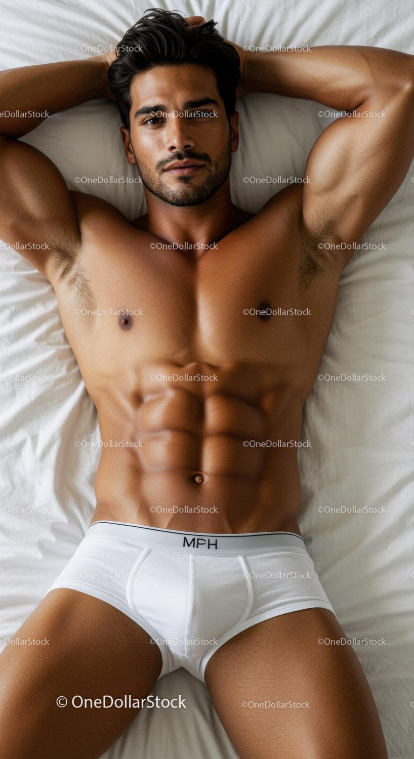 Fit man relaxing on bed wearing white underwear