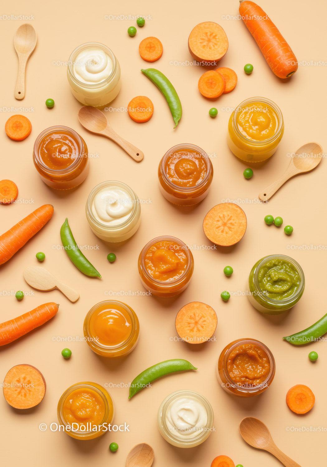 Jars of colorful baby food with fresh vegetables
