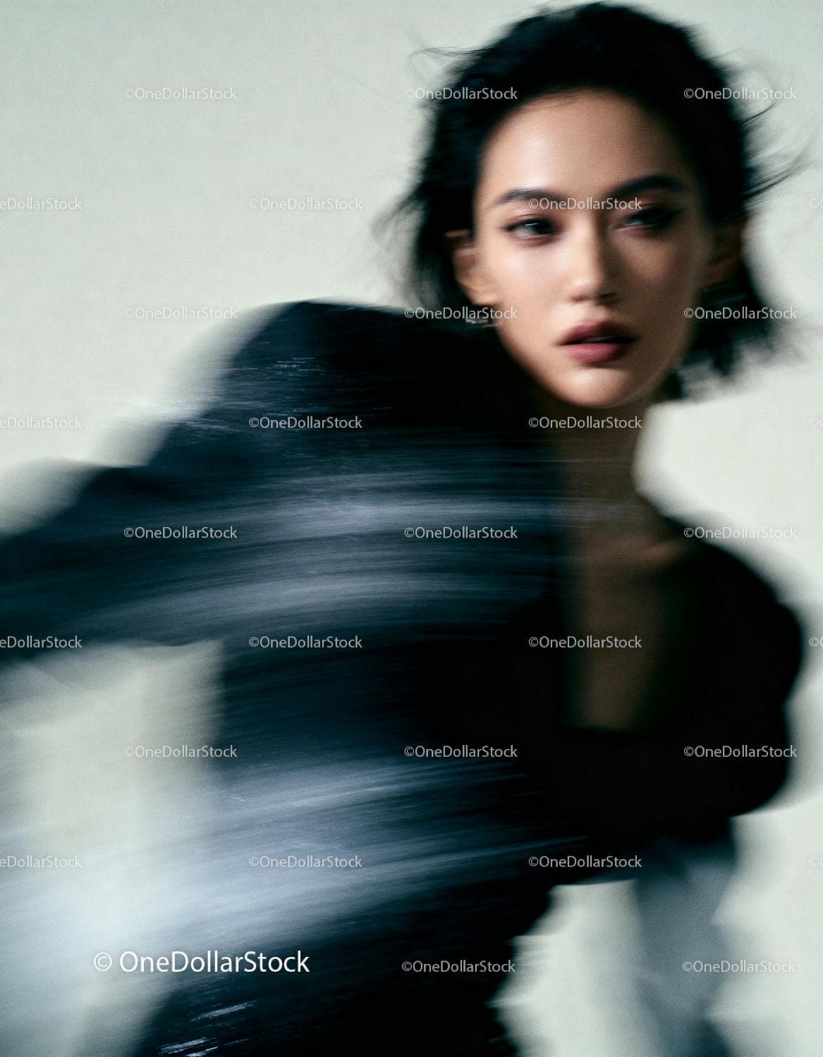 Blurred portrait of stylish woman in motion