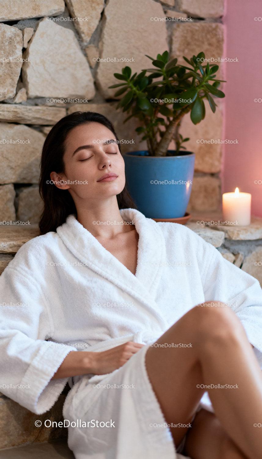 Relaxed woman enjoying calm moment in spa robe