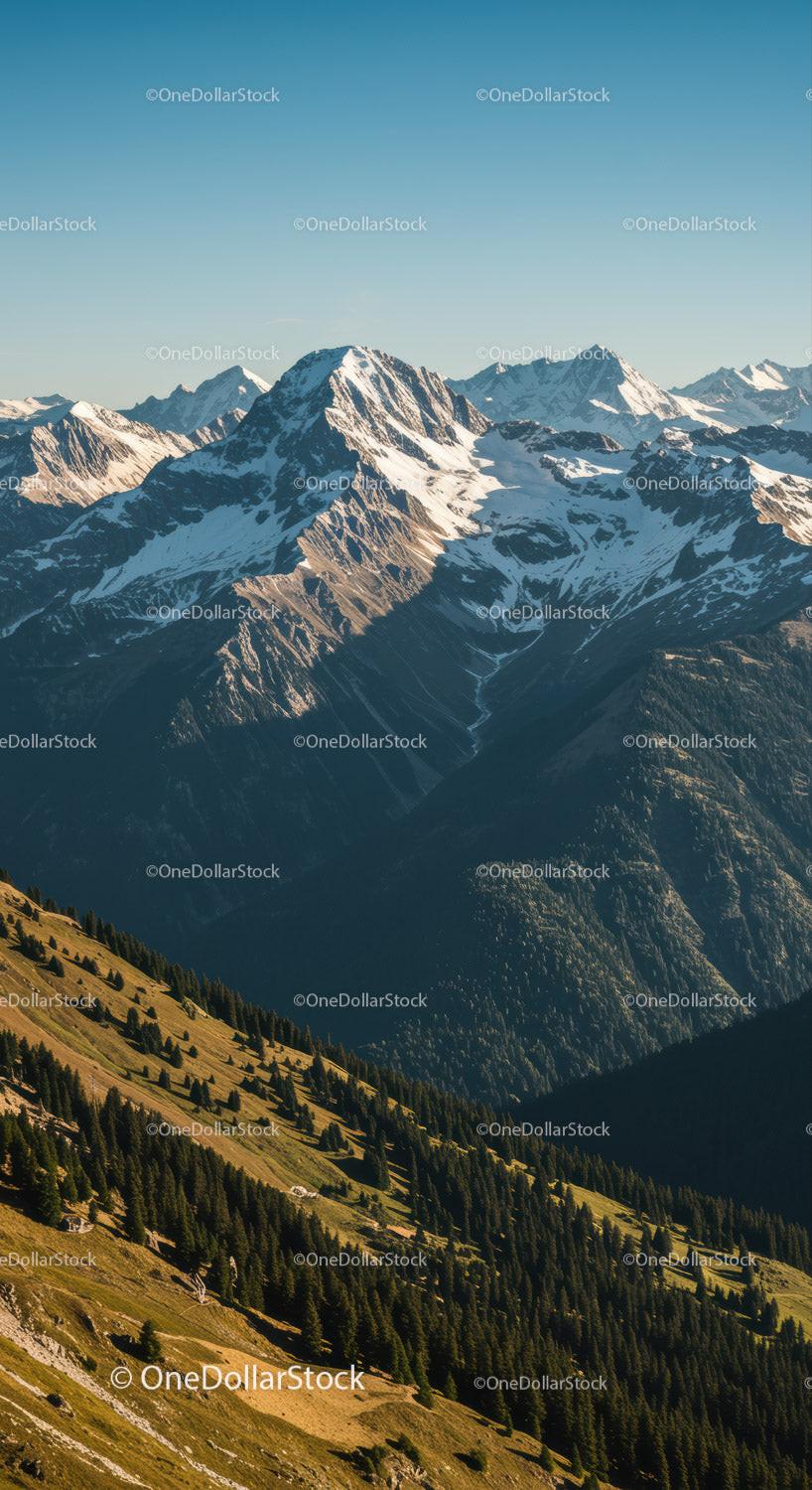 Majestic Snow-Capped Mountain Range with Green Forests and Scenic Views